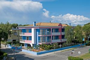 a building with pink and blue at Villa Boer in Bibione