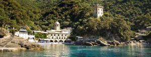 a large building on the side of a body of water at Appartamento Portofino in Portofino