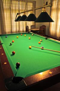 a pool table with balls on top of it at Ancoombra Tea Estate Bungalow in Matale