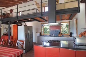 a large kitchen with red cabinets and a refrigerator at Spacious Villa in Parecag with a Swimming Pool in Sečovlje