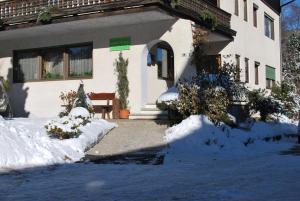 a house with snow on the ground in front of it at App Brunner in Valdaora