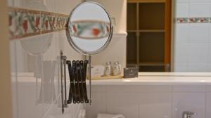 a mirror hanging on a wall in a bathroom at Tuscany Downs Estate in Darfield +64 photos