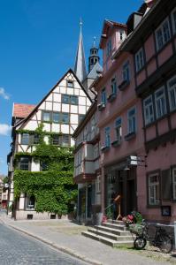 eine Straße in einer Stadt mit Gebäuden und einer Kirche in der Unterkunft Hotel am Hoken in Quedlinburg
