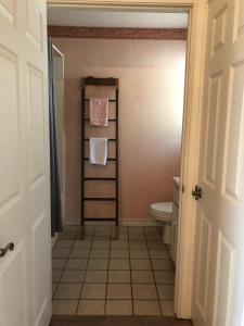 a bathroom with a toilet and towels on a towel rack at Perfect Country-Side Get-Away in Boerne