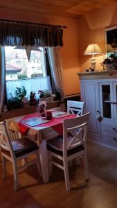 a table and chairs in a room with a window at Pension a la Kleinert in Weimar