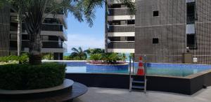 a swimming pool in the middle of a building at Landscape Diamond 1409 in Fortaleza
