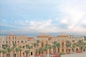 a rendering of the exterior of a building with palm trees at Villages road Suite in Hurghada