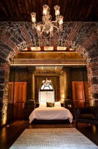 a bedroom with a bed in a brick wall at Casa San Jacinto in Mexico City
