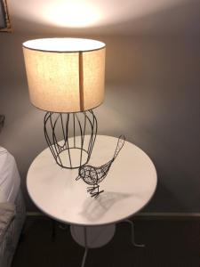 a lamp on a table with a chicken on it at The Old Coolstore - Braeburn Apt in Merricks North