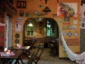 a restaurant with tables and chairs in a room at Casa Moinhos de Vento Vintage in Porto Alegre