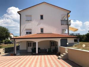 a large white house with a large patio at Guesthouse Pejo in Poreč