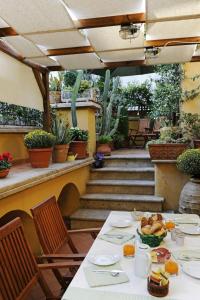 a table with plates of food on a patio at Palazzo Maggiore in Tivoli