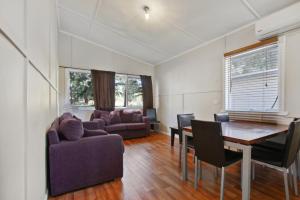 a living room with a couch and a table and chairs at Dargo River Inn in Dargo
