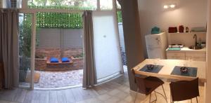 a kitchen with a large sliding glass door to a patio at Loft, Bikes & Optic Fibre WIFI by Top Bar St and Park in Mendoza