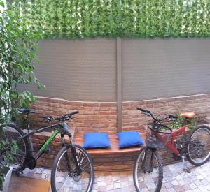 two bikes parked in front of a bench at Loft, Bikes & Optic Fibre WIFI by Top Bar St and Park in Mendoza