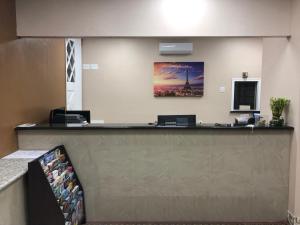 a reception desk in a hotel lobby with at Villa West Inn in Odessa