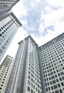 a group of tall buildings in a city at M-Town Residence Gading Serpong by Taslim Property in Tangerang