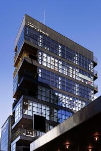 a tall building with a lot of windows at MANGA ART HOTEL, TOKYO in Tokyo