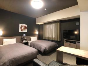 Säng eller sängar i ett rum på Hotel Route-Inn Tsuchiura