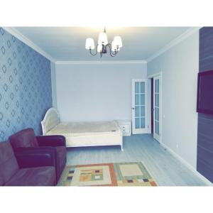 a living room with a bed and a couch at Best apartment on Sauran Towers in Astana