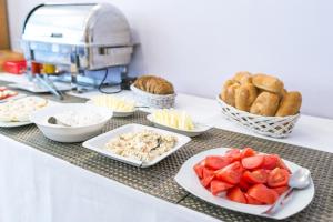 a table topped with plates of food and bread at SCSK Brzeźno in Gdańsk
