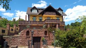 una casa en la parte superior de una pared de piedra en Balatoni Panoráma Villa, en Balatonalmádi