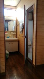 a bathroom with a sink and a toilet at Nobu Guest House in Kanayama