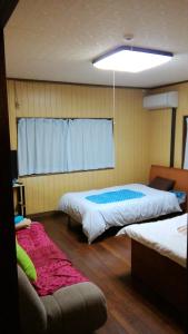 Postel nebo postele na pokoji v ubytování Nobu Guest House