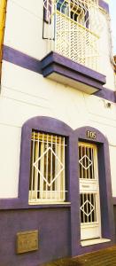 um edifício roxo e branco com um sinal de tos sobre ele em Abá apartamento em Almeria