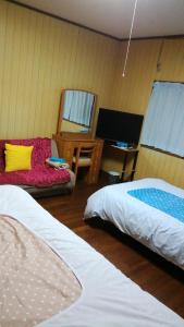 Postel nebo postele na pokoji v ubytování Nobu Guest House