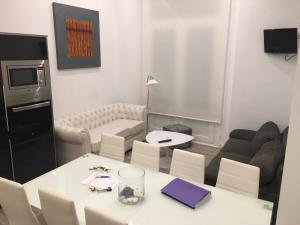 a small living room with a white table and chairs at Malaga BnB in Málaga