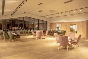 a restaurant with tables and chairs in a room at Complex Hotelier COTA O MIE in Sinaia