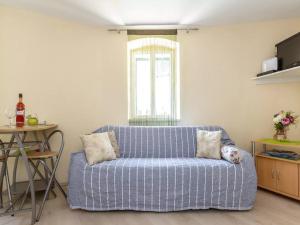 a blue couch in a living room with a window at Apartment Bova in Split