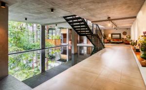 
a large room with a staircase leading up to a balcony at Bisma Eight - CHSE Certified in Ubud
