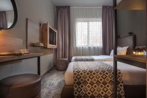 a hotel room with two beds and a window at The Stay by Aston Hotel Central Square - Free Compliments - Free Wi-Fi - TOP LOCATION - Nearby Paid Parking in Plovdiv