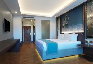 Postel nebo postele na pokoji v ubytování Chanalai Garden Resort, Kata Beach