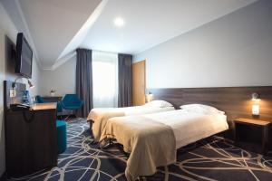 Posteľ alebo postele v izbe v ubytovaní Hotel Nad Nettą