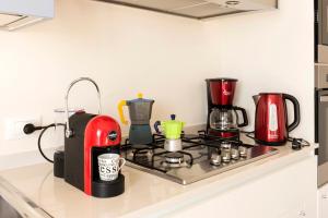 a kitchen counter with a stove top with appliances on it at Agrifoglio in Baveno