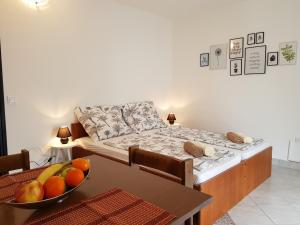 a room with a bed and a table with a bowl of fruit at Casa Nostra II - Sunny Holiday Stay Near the Beach in Funtana