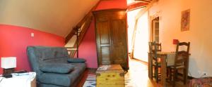 a living room with a couch and a chair at Chambre d'Hotes La Mexicaine in Jausiers