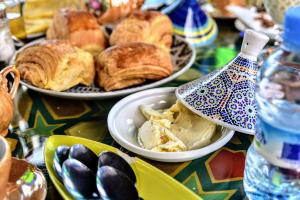 a table topped with plates of pastries and other foods at Riad Razoli Sidi Fateh in Rabat +59 photos