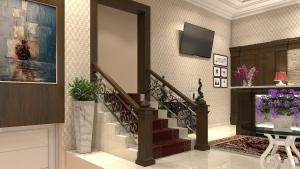 a living room with a staircase and a tv at Pensiunea Elisei in Timişoara