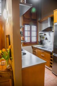 a kitchen with a sink and a counter top at Abades Giralda View by Valcambre in Seville