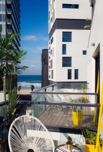 a car parked in front of a building with a view of the ocean at Beach House Tel-Aviv a member of Brown Hotels in Tel Aviv