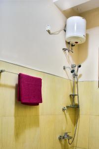 a bathroom with a red towel hanging on a wall at Villa Hikka 08 in Hikkaduwa