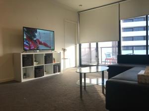 a living room with a couch and a flat screen tv at New Luxurious Skyview 2Bedroom Apartment Liverpool in Liverpool