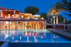 a house with a swimming pool in front of a house at Boutique Hotel Vivenda Miranda in Lagos