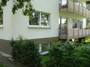 a white building with windows and a balcony at Ferienwohnung Umkirch in Umkirch