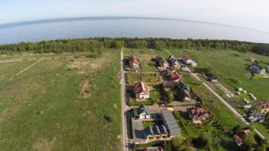 an aerial view of a house on a hill next to the water at Domki Gala - blisko plaży i centrum in Grzybowo