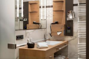 a bathroom with a sink and a mirror at Rosenhof in Stetten +36 photos